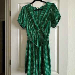 Green with white polka dot dress .